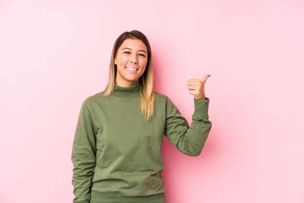 Young caucasian woman posing   smiling and raising thumb up