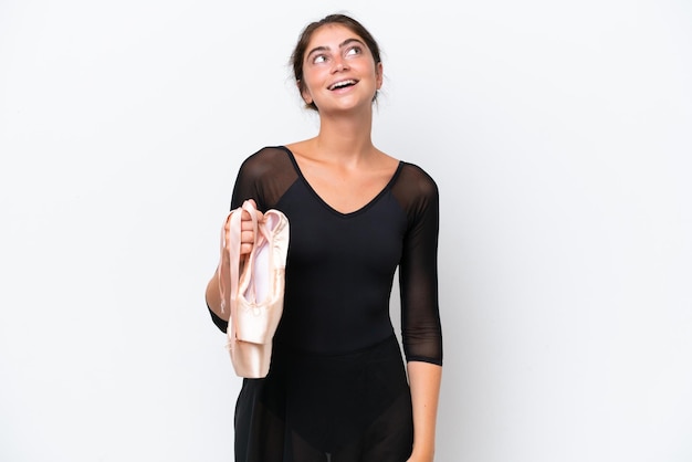 Young caucasian woman practicing ballet isolated on white background laughing