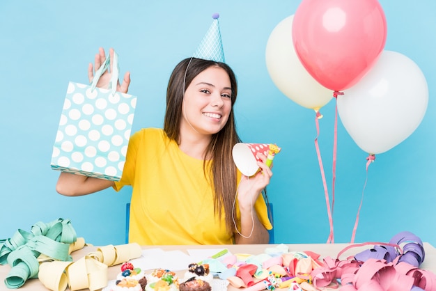 Young caucasian woman preparing a birthday party