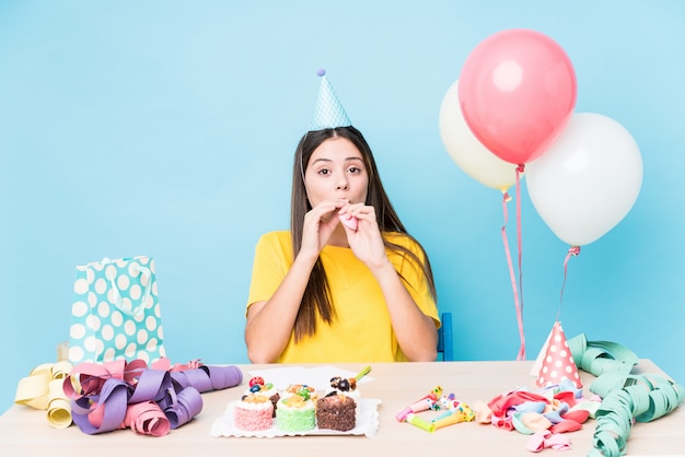 Young caucasian woman preparing a birthday party