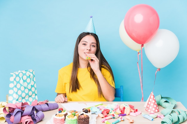 Young caucasian woman preparing a birthday party