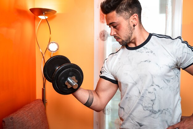 Young caucasian woman raising weights at home