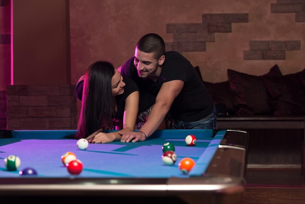 Young Caucasian Woman Receiving Advice On Shooting Pool Ball While Playing Billiards