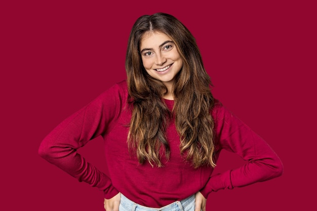 Young Caucasian woman in red sweater in studio