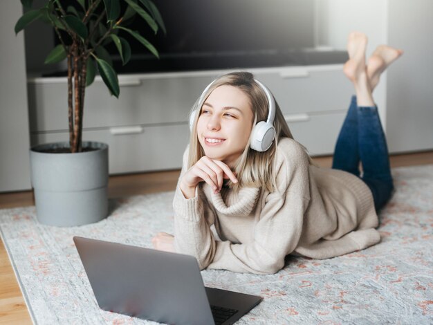 Young caucasian woman relaxes at home with music