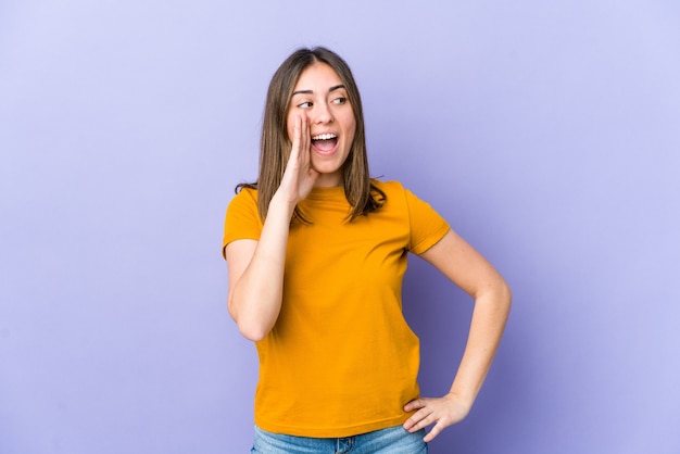 Young caucasian woman shouting excited to front.