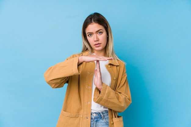 Young caucasian woman showing a timeout gesture.