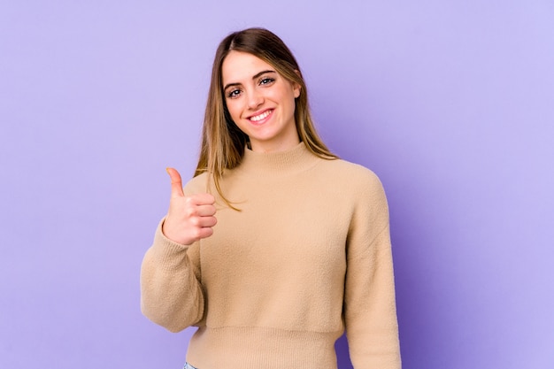 Young caucasian woman smiling and raising thumb up