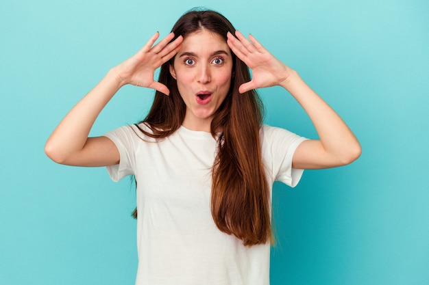 Young caucasian woman surprised and shocked.