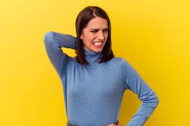 Young caucasian woman tired and very sleepy keeping hand on head.