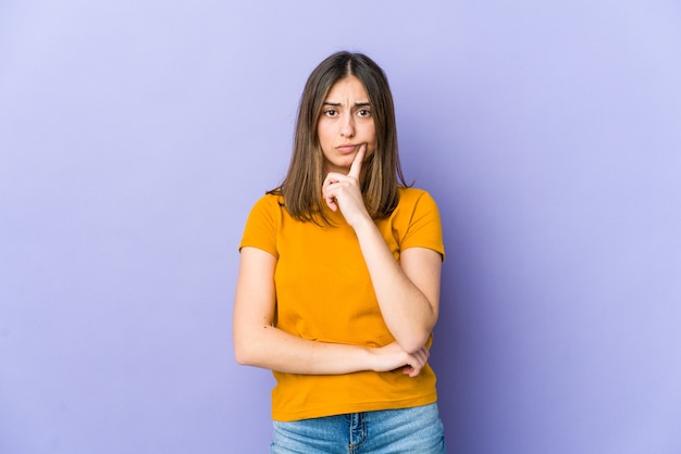 Young caucasian woman unhappy looking in camera with sarcastic expression.