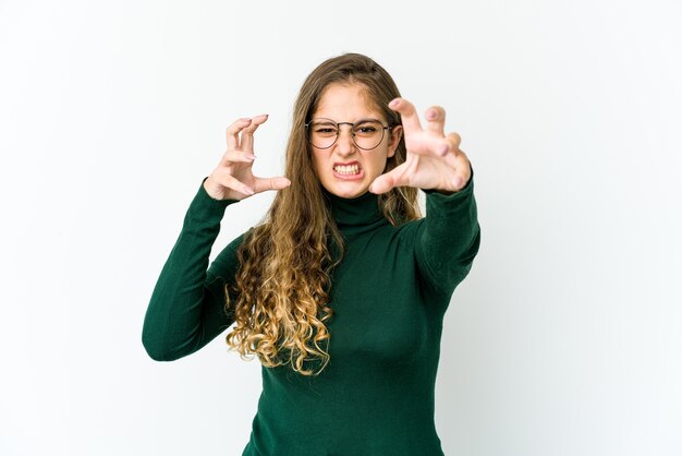 Young caucasian woman upset screaming with tense hands.