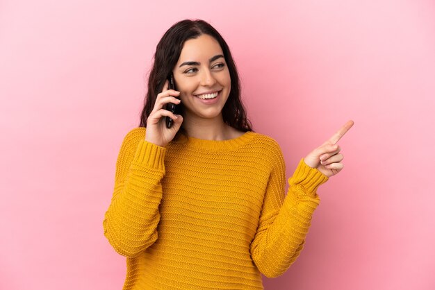 Young caucasian woman using mobile phone isolated