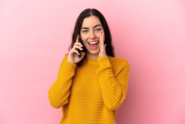 Young caucasian woman using mobile phone isolated