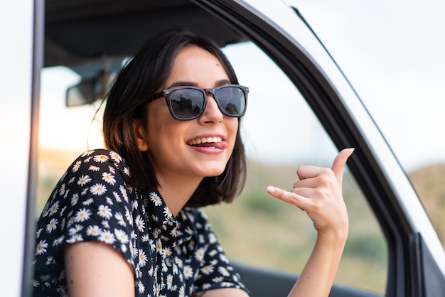 Young caucasian woman in a van at outdoors