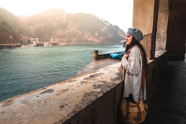 Young caucasian woman visiting an old town at the river side