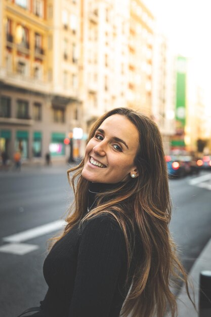 Young caucasian woman walking through the streets of Madrid, Spain.