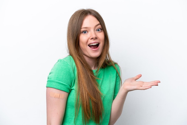 Young caucasian woman wearing a band aids isolated on white background with shocked facial expression