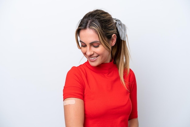 Young caucasian woman wearing bandaids isolated on white background smiling a lot