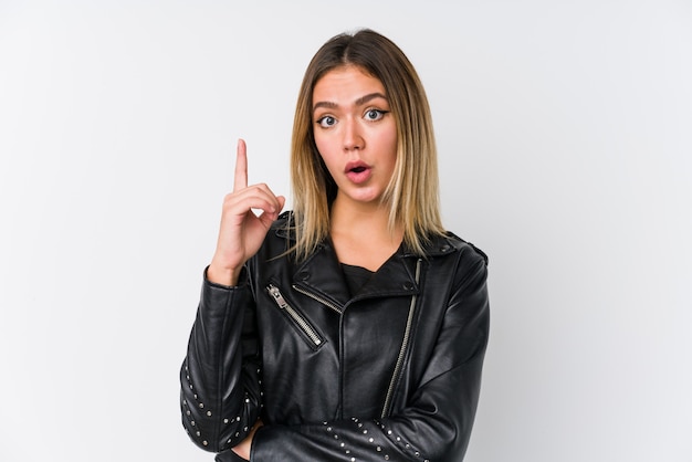 Young caucasian woman wearing a black leather jacket having some great idea, concept of creativity.