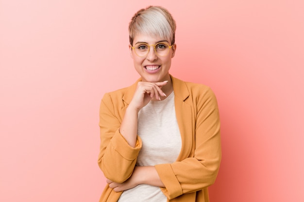 Young caucasian woman wearing a casual business clothes smiling happy and confident, touching chin with hand