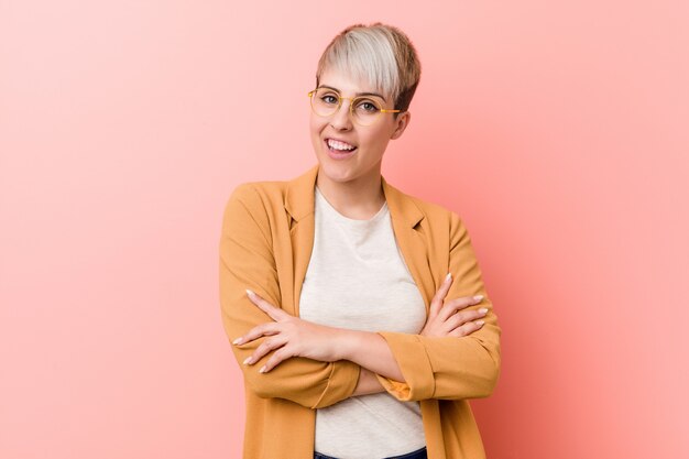 Young caucasian woman wearing a casual business clothes who feels confident, crossing arms with determination.