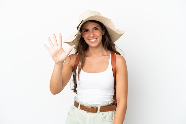 Young caucasian woman wearing a Pamela in summer holidays isolated on white background counting five with fingers