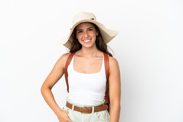 Young caucasian woman wearing a Pamela in summer holidays isolated on white background laughing