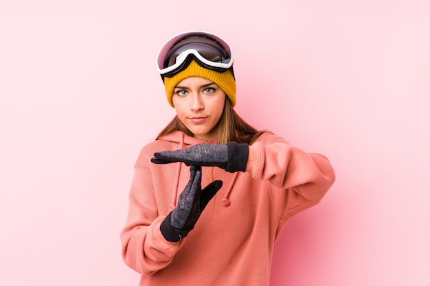 Young caucasian woman wearing a ski clothes showing a timeout gesture.