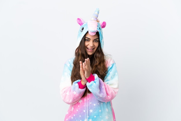 Young caucasian woman wearing a unicorn pajama isolated on white background applauding after presentation in a conference