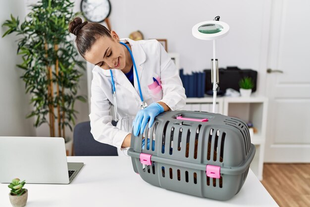 Young caucasian woman wearing veterinarian uniform working at veterinary