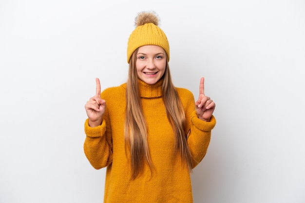 Young caucasian woman wearing winter jacket isolated on white background pointing up a great idea