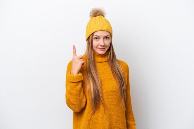 Young caucasian woman wearing winter jacket isolated on white background pointing with the index finger a great idea
