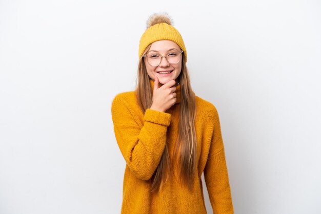 Young caucasian woman wearing winter jacket isolated on white background with glasses and smiling