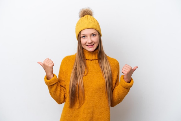 Young caucasian woman wearing winter jacket isolated on white background with thumbs up gesture and smiling