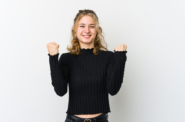 Young caucasian woman on white backrgound cheering carefree and excited. Victory concept.