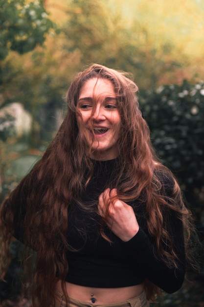 Young caucasian woman with casual clothes posing in the the forest.