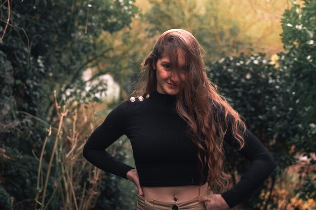 Young caucasian woman with casual clothes posing in the the forest.