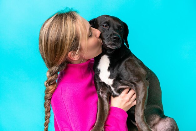 Young caucasian woman with her dog over isolated background