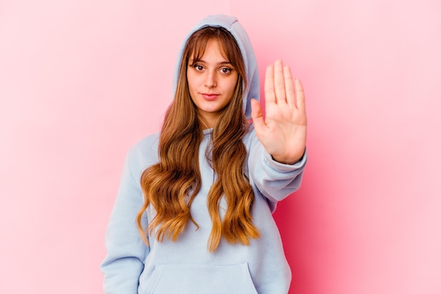 Young caucasian woman with hood isolated