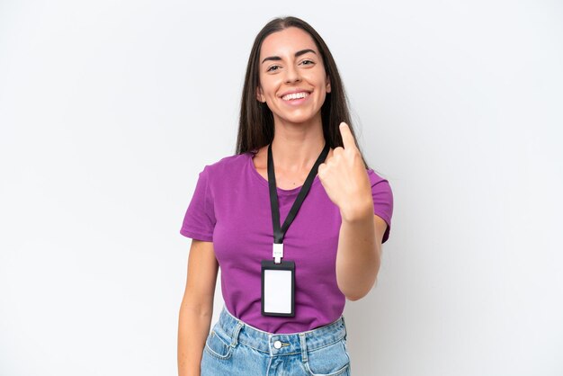 Young caucasian woman with ID card isolated on white background doing coming gesture