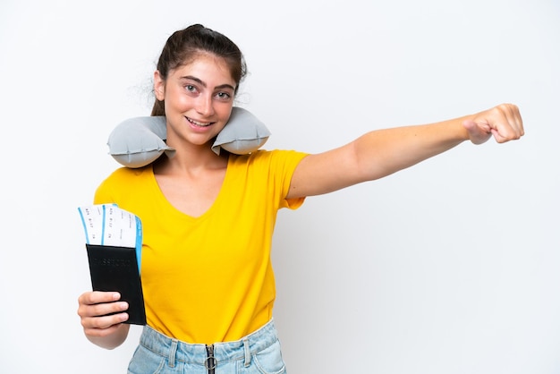 Young caucasian woman with Inflatable travel pillowisolated on white background giving a thumbs up gesture