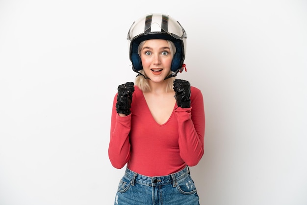 Young caucasian woman with a motorcycle helmet isolated on white background celebrating a victory in winner position