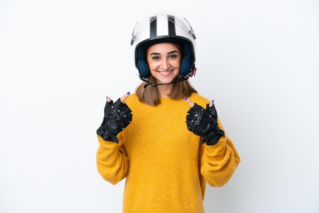 Young caucasian woman with a motorcycle helmet isolated on\
white background giving a thumbs up gesture