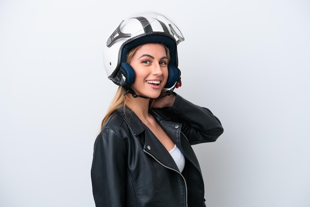 Young caucasian woman with a motorcycle helmet isolated on\
white background laughing