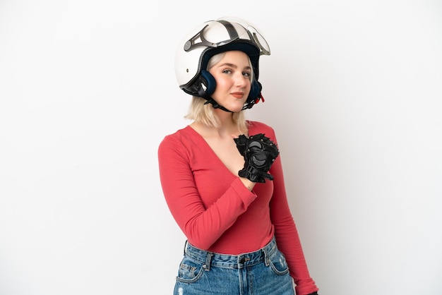 Young caucasian woman with a motorcycle helmet isolated on white background proud and self-satisfied