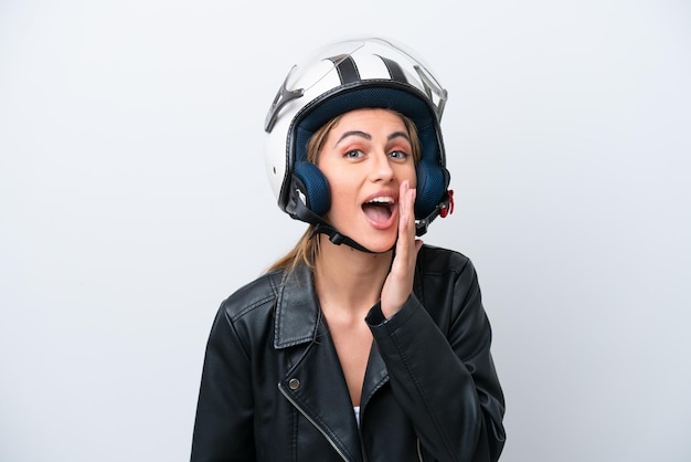 Young caucasian woman with a motorcycle helmet isolated on white background shouting with mouth wide open