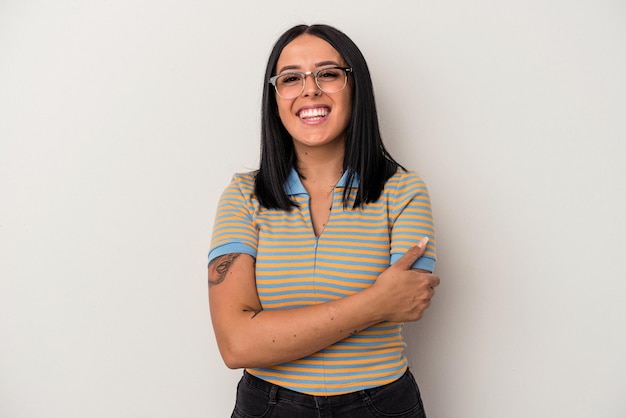 Young caucasian woman with one arm isolated on white background laughing and having fun.