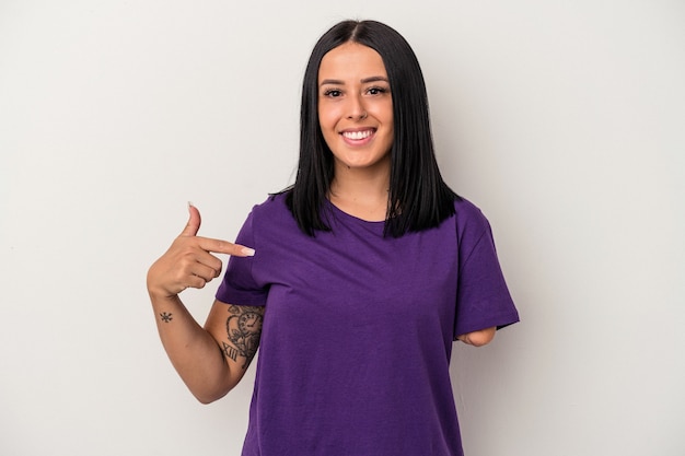 Young caucasian woman with one arm isolated on white background person pointing by hand to a shirt copy space, proud and confident