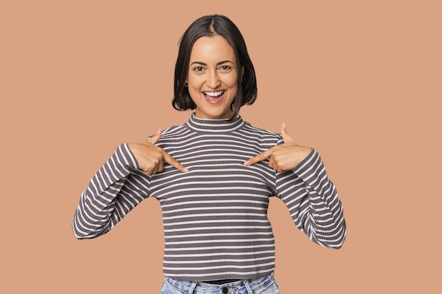 Young Caucasian woman with short hair surprised pointing with finger smiling broadly